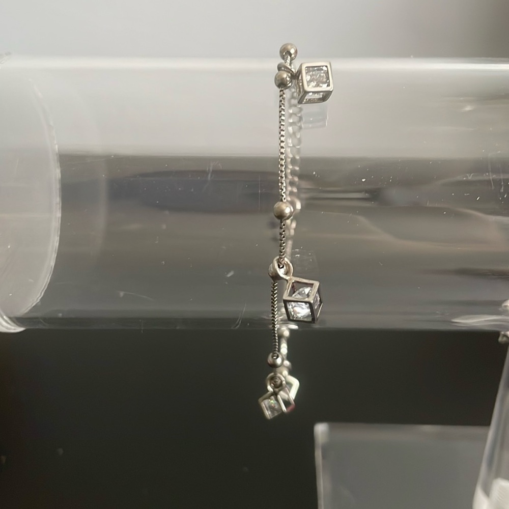 Delicate silver bracelet with small dangly charms